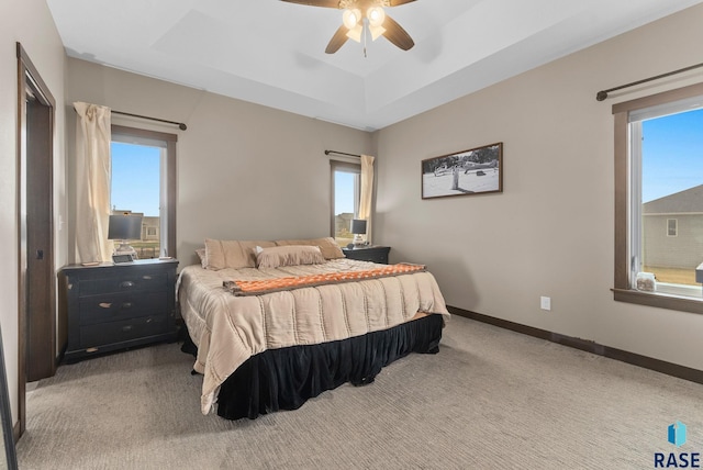 5320 S Solono Ave, Sioux Falls, SD 57108 - bedroom featuring a raised ceiling, carpet flooring, a ceiling fan, and multiple windows