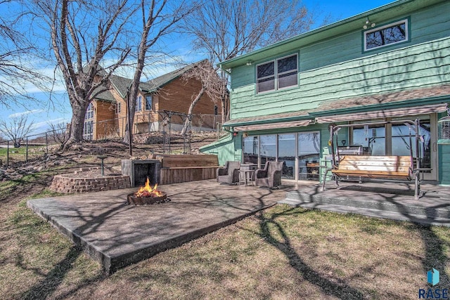 rear view of house with a patio area, fence, and a fire pit