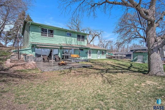 back of house with a patio area and a yard