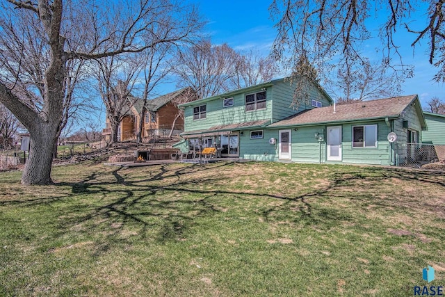 rear view of house with a yard, a patio, and fence