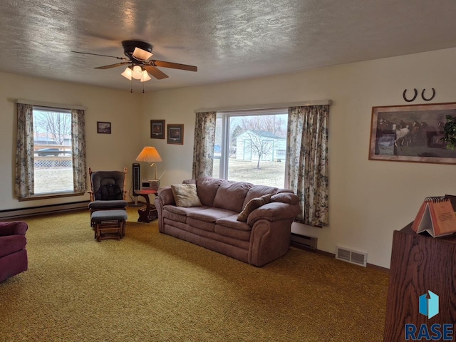 living area featuring plenty of natural light, carpet, visible vents, and a ceiling fan