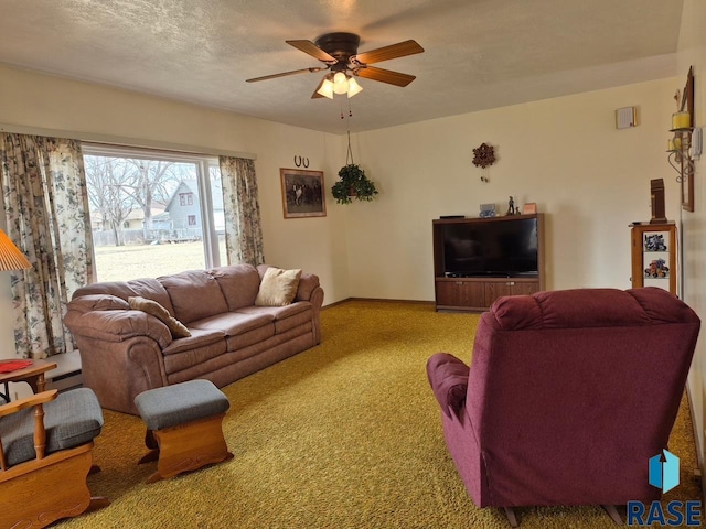 carpeted living room with baseboards and a ceiling fan