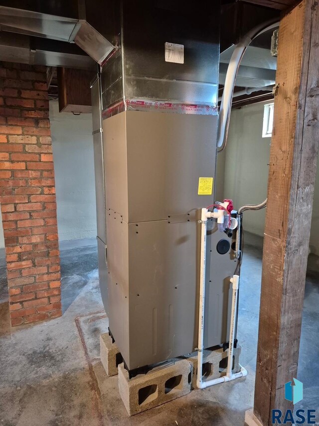 utility room featuring heating unit