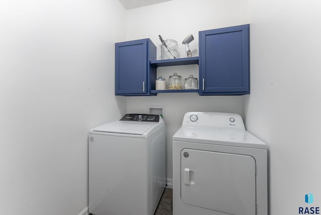 laundry room with separate washer and dryer, baseboards, and cabinet space