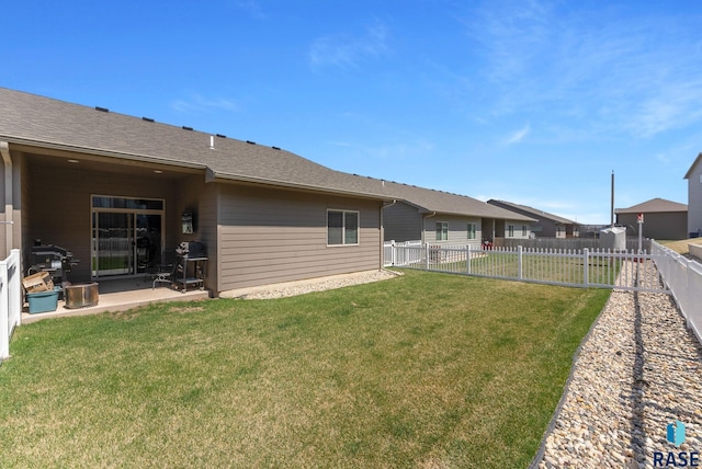 back of property featuring a fenced backyard, a yard, and a patio