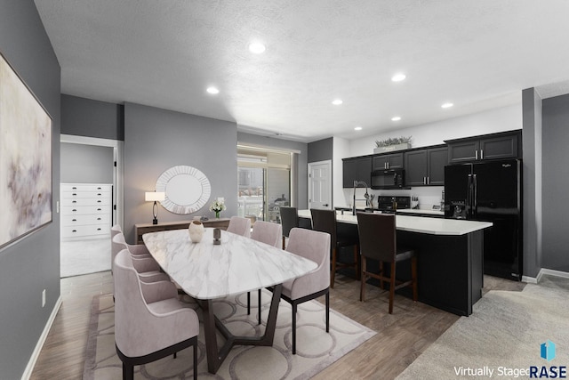 dining room featuring recessed lighting, light wood-style floors, and baseboards