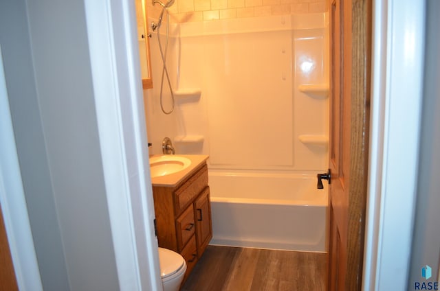 full bathroom featuring shower / washtub combination, toilet, vanity, and wood finished floors