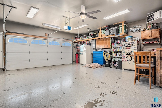 garage with freestanding refrigerator, ceiling fan, and a garage door opener