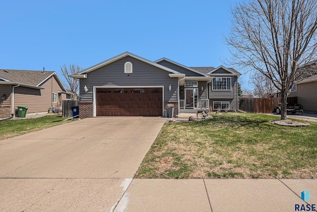 view of front of home featuring a garage, driveway, a front yard, and fence