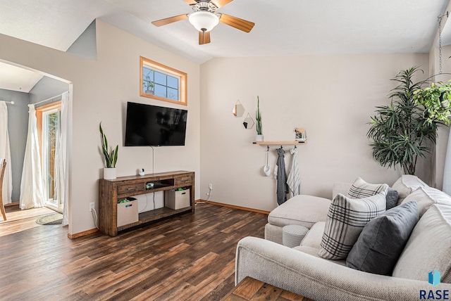 living room featuring ceiling fan, baseboards, wood finished floors, and plenty of natural light