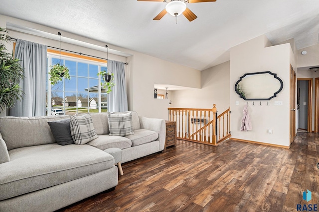 living area featuring baseboards, vaulted ceiling, wood finished floors, and ceiling fan