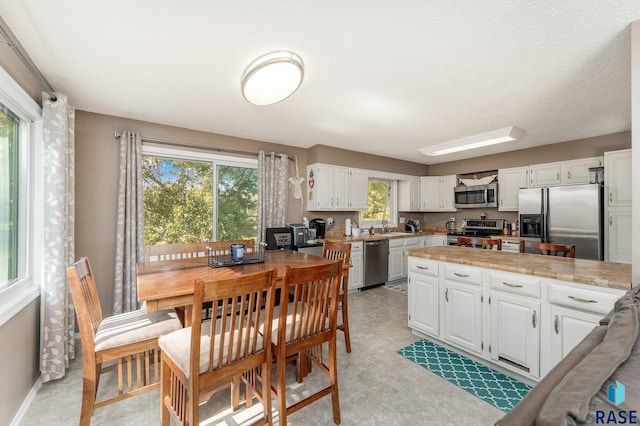 47205 94th St, Sioux Falls, SD 57108 - kitchen with light countertops, appliances with stainless steel finishes, white cabinetry, and a sink