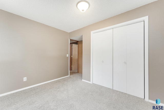 47205 94th St, Sioux Falls, SD 57108 - unfurnished bedroom with a textured ceiling, carpet floors, a closet, and baseboards