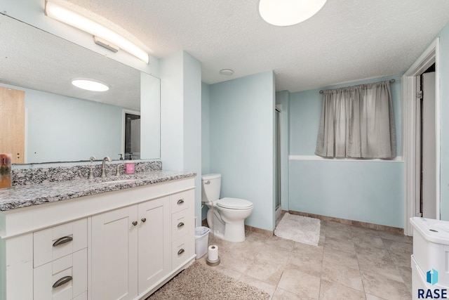 47205 94th St, Sioux Falls, SD 57108 - full bathroom with a textured ceiling, toilet, baseboards, a shower with door, and vanity