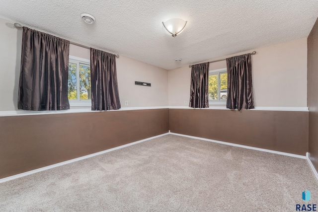 47205 94th St, Sioux Falls, SD 57108 - carpeted spare room with baseboards and a textured ceiling