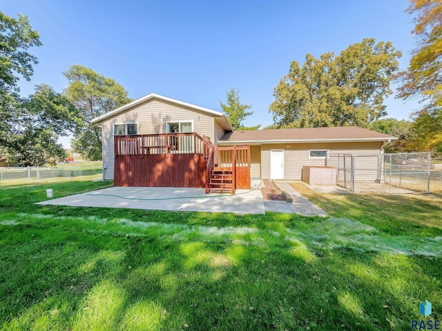 47205 94th St, Sioux Falls, SD 57108 - back of house with a fenced backyard, a wooden deck, a patio area, and a lawn