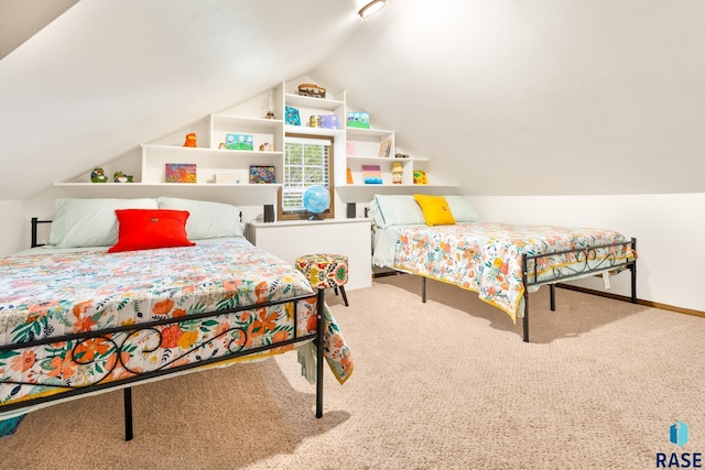 carpeted bedroom featuring lofted ceiling and baseboards