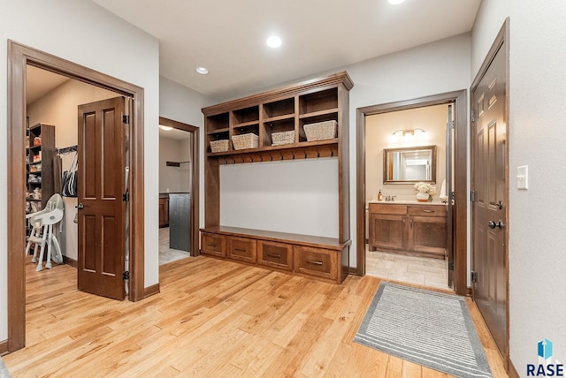mudroom with light wood-style flooring, baseboards, and recessed lighting