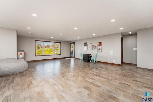 unfurnished living room featuring light wood-style flooring, baseboards, and recessed lighting