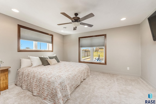 bedroom featuring recessed lighting, baseboards, and light colored carpet