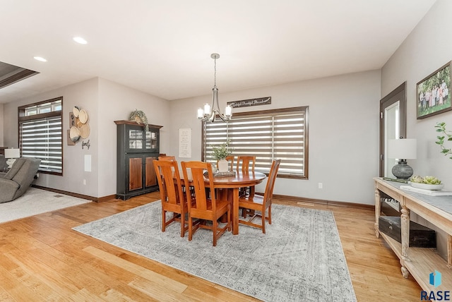dining room featuring recessed lighting, baseboards, a chandelier, and light wood-style flooring