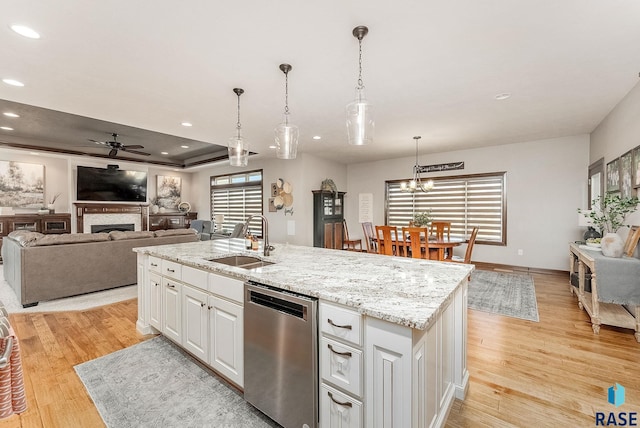 kitchen with recessed lighting, light wood finished floors, dishwasher, a sink, and ceiling fan with notable chandelier