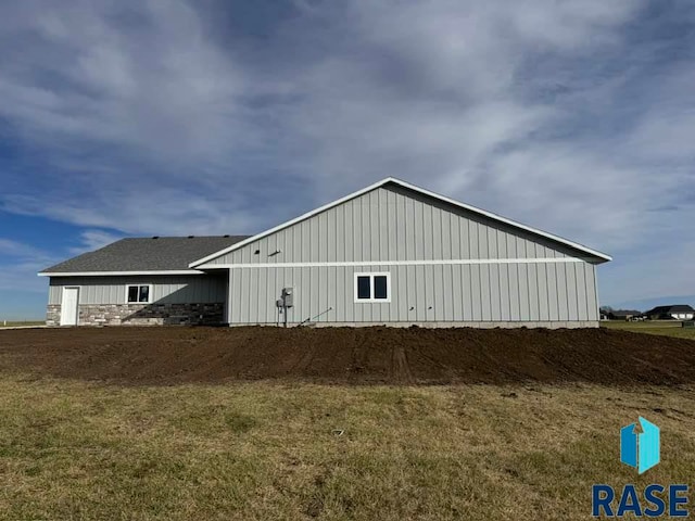 view of side of property featuring board and batten siding and stone siding