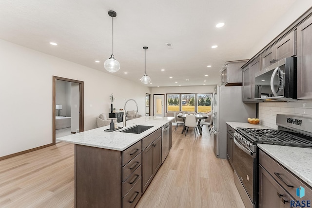 kitchen with light wood-style floors, recessed lighting, a sink, and stainless steel appliances