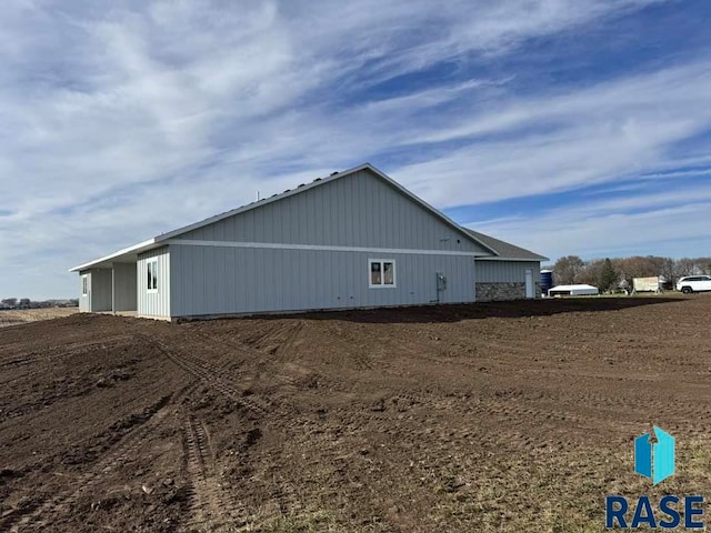 view of home's exterior with an outbuilding