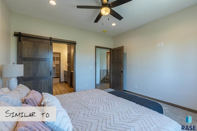 bedroom with a barn door, baseboards, a spacious closet, recessed lighting, and a ceiling fan