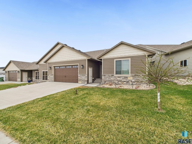 view of front of home featuring stone siding, an attached garage, a front lawn, and concrete driveway