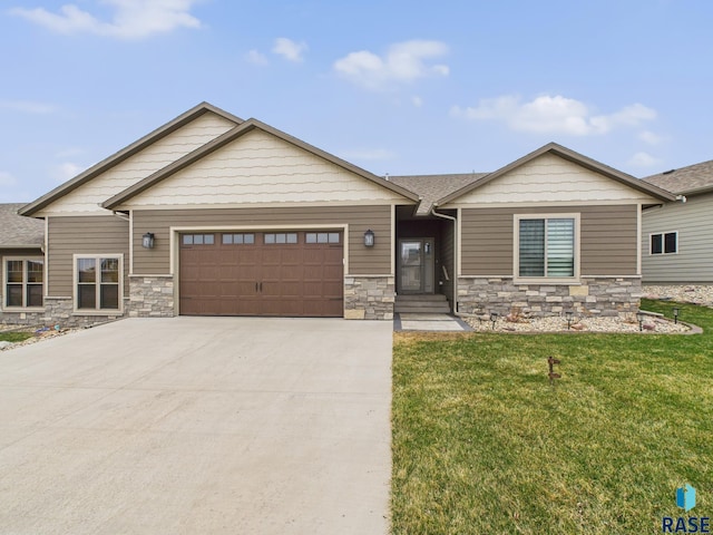 view of front of home featuring driveway, stone siding, an attached garage, a shingled roof, and a front yard