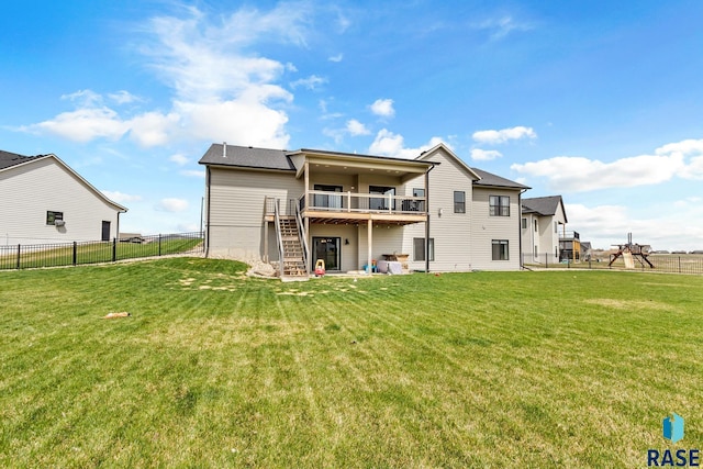 back of property with a fenced backyard, stairway, and a yard
