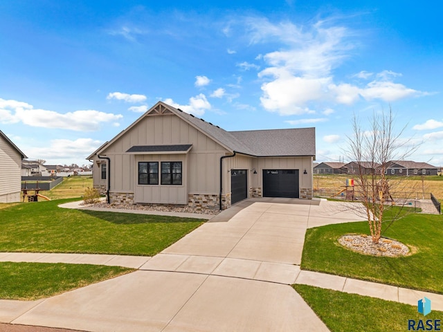 view of front of house with board and batten siding, driveway, a front yard, and a garage