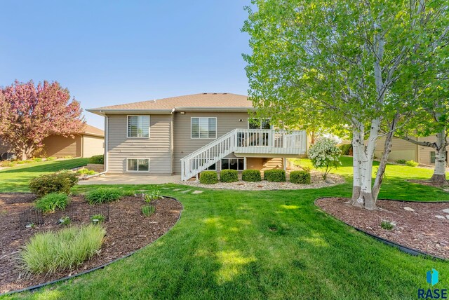 rear view of property with stairs, a patio area, a deck, and a lawn