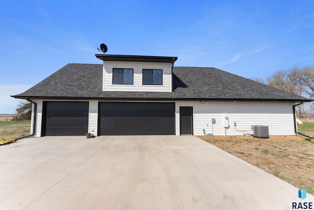 46736 306th St, Beresford, SD 57004 - view of front of property with central AC, an attached garage, concrete driveway, and a shingled roof