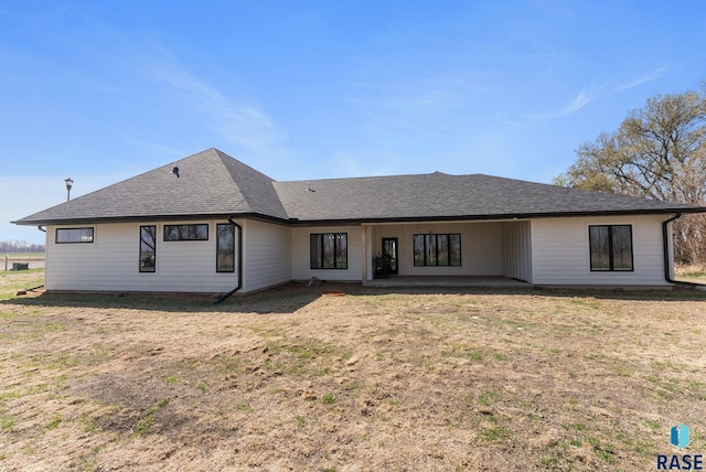 46736 306th St, Beresford, SD 57004 - rear view of house featuring a shingled roof, a patio area, and a lawn