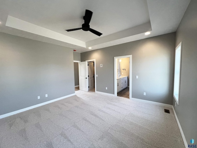 2613 S Galena Ave, Sioux Falls, SD 57110 - unfurnished bedroom featuring a tray ceiling, baseboards, carpet flooring, ensuite bath, and recessed lighting