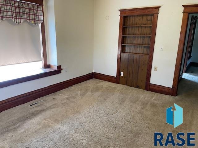 1131 Williams St, Larchwood, IA 51241 - carpeted empty room featuring visible vents and baseboards