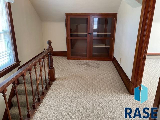 1131 Williams St, Larchwood, IA 51241 - corridor with carpet flooring and an upstairs landing