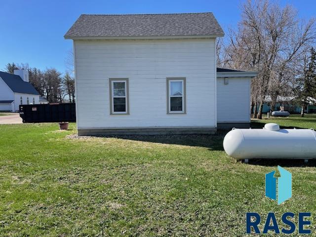 1131 Williams St, Larchwood, IA 51241 - view of property exterior with a yard and roof with shingles