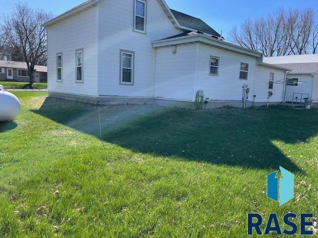 1131 Williams St, Larchwood, IA 51241 - rear view of house featuring a lawn