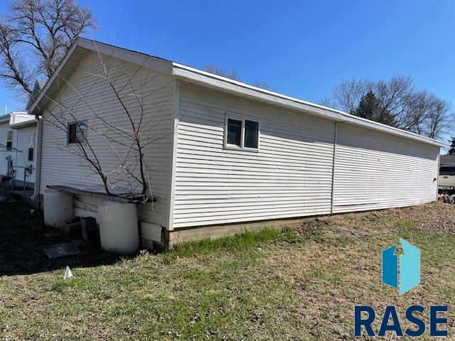1131 Williams St, Larchwood, IA 51241 - view of side of home featuring a lawn