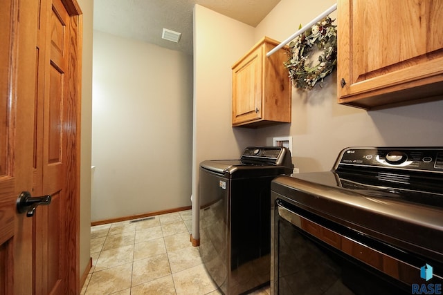 7304 W Lobelia St, Sioux Falls, SD 57106 - washroom with a textured ceiling, visible vents, washing machine and dryer, cabinet space, and baseboards