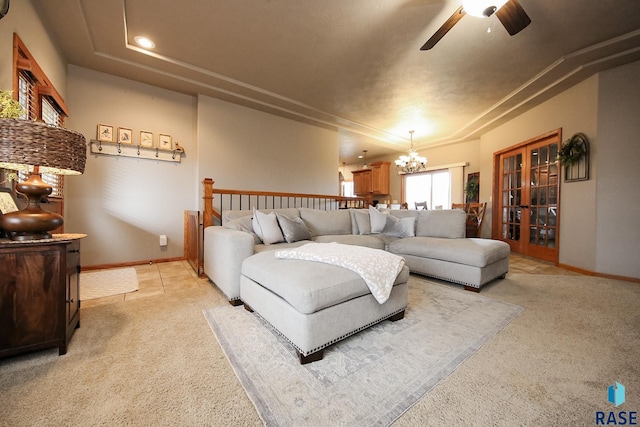7304 W Lobelia St, Sioux Falls, SD 57106 - living room featuring light colored carpet, baseboards, ceiling fan with notable chandelier, and french doors