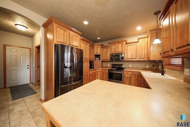 7304 W Lobelia St, Sioux Falls, SD 57106 - kitchen featuring arched walkways, a sink, light countertops, a peninsula, and stainless steel appliances