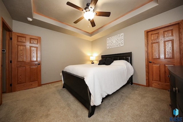 7304 W Lobelia St, Sioux Falls, SD 57106 - bedroom with a raised ceiling, baseboards, and light colored carpet