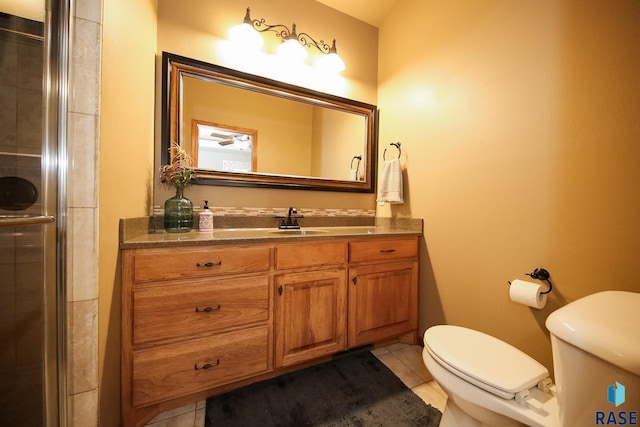 7304 W Lobelia St, Sioux Falls, SD 57106 - full bathroom featuring tile patterned flooring, an enclosed shower, toilet, and vanity