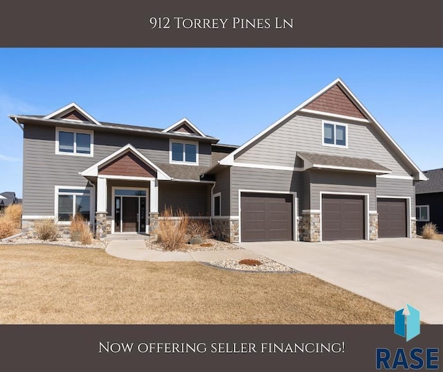 912 Torrey Pine Ln, Sioux Falls, SD 57110 - view of front of home featuring a front lawn, driveway, stone siding, and a garage