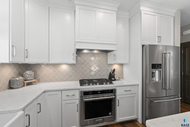 912 Torrey Pine Ln, Sioux Falls, SD 57110 - kitchen with light stone counters, stainless steel appliances, backsplash, white cabinetry, and dark wood-style flooring